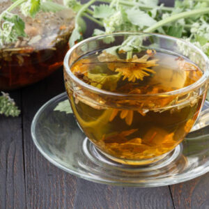 Cups of mint tea on table