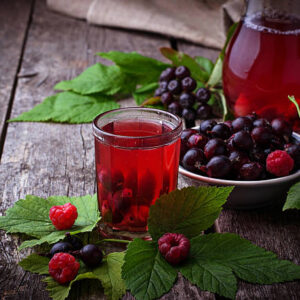 Fresh berry drink with black currant and raspberries. selective focus