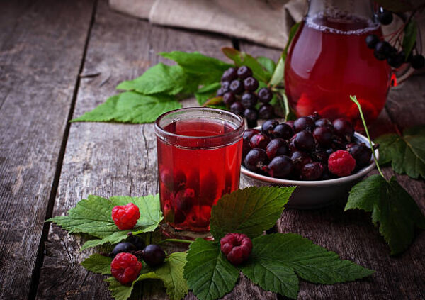 Fresh berry drink with black currant and raspberries. selective focus